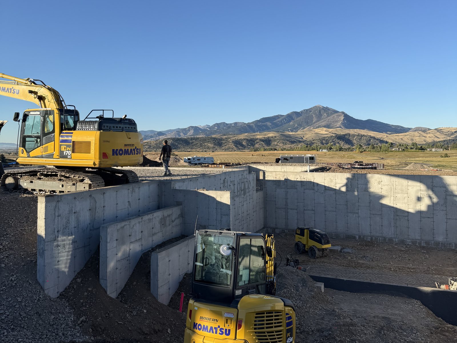 Excavators over freshly stripped foundation walls — Walls No. 002
